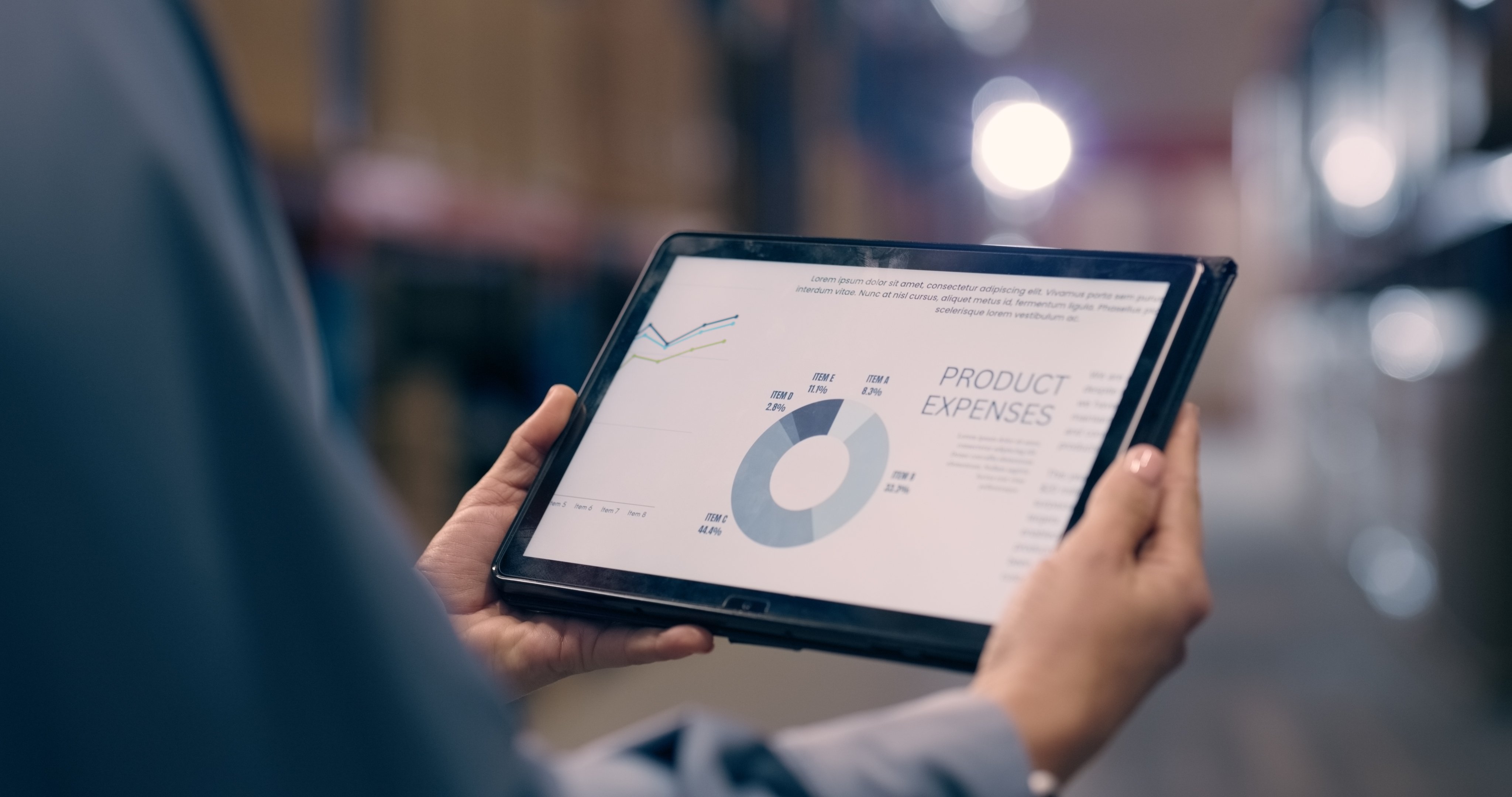 Person holding iPad with graph in chemical plant
