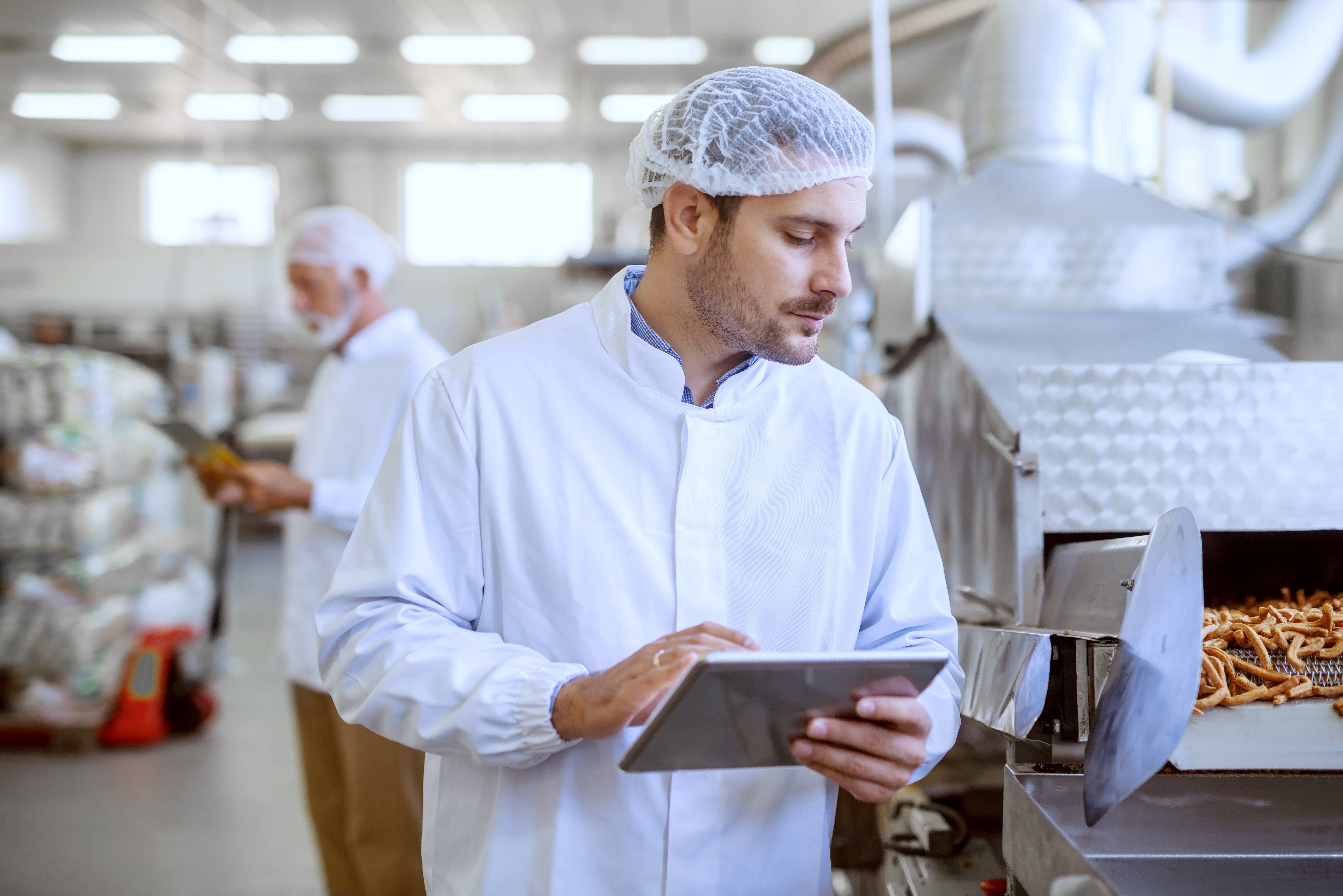 Supervisor Inspecting Food Quality with Tablet